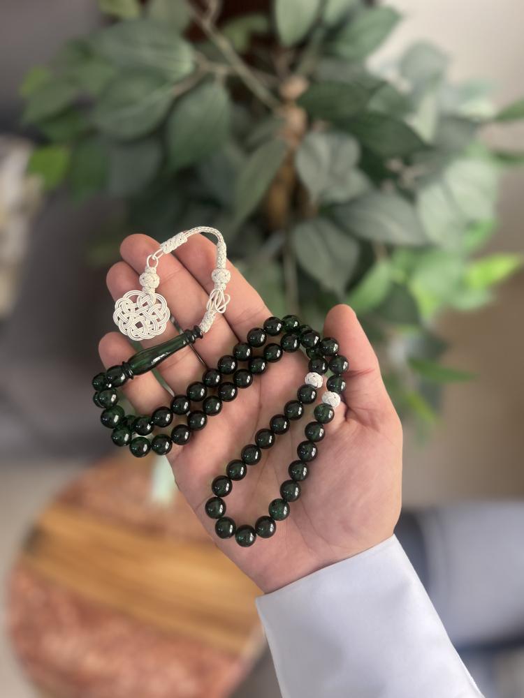 Green plastic prayer beads with Tasbih.