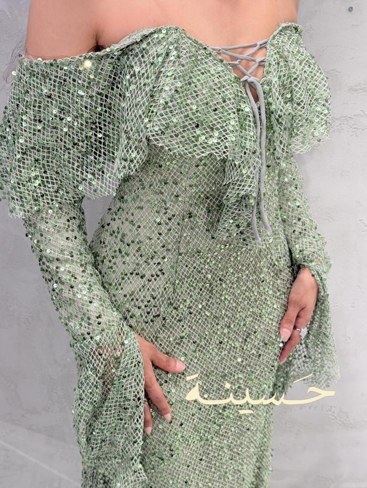 فستان أخضر لامع بأكمام طويلة واسعة