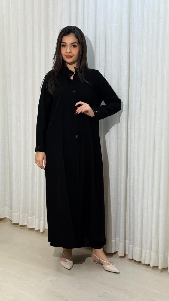 Noura Abaya with flared design made of Indonesian fabric, with a decorative piece in the front and on the sleeves.