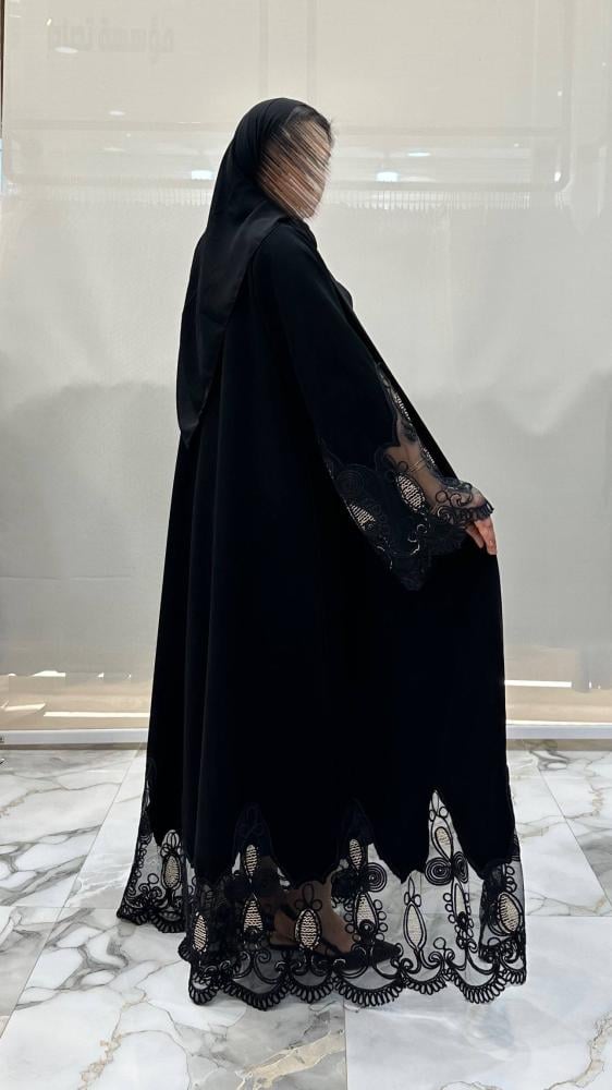 Beautiful abaya with wide cut, made of dark black fabric, with unique embroidery.