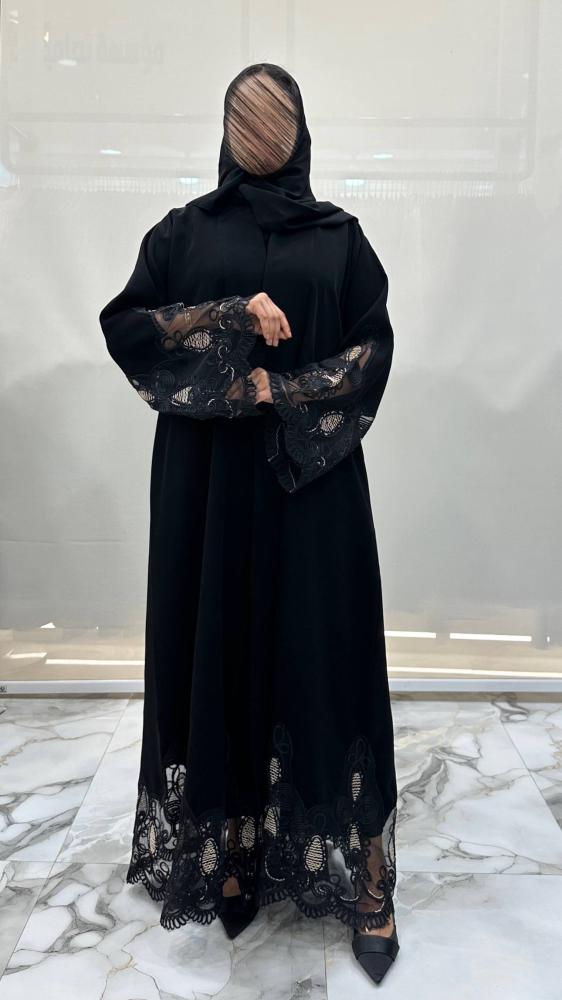 Beautiful abaya with wide cut, made of dark black fabric, with unique embroidery.