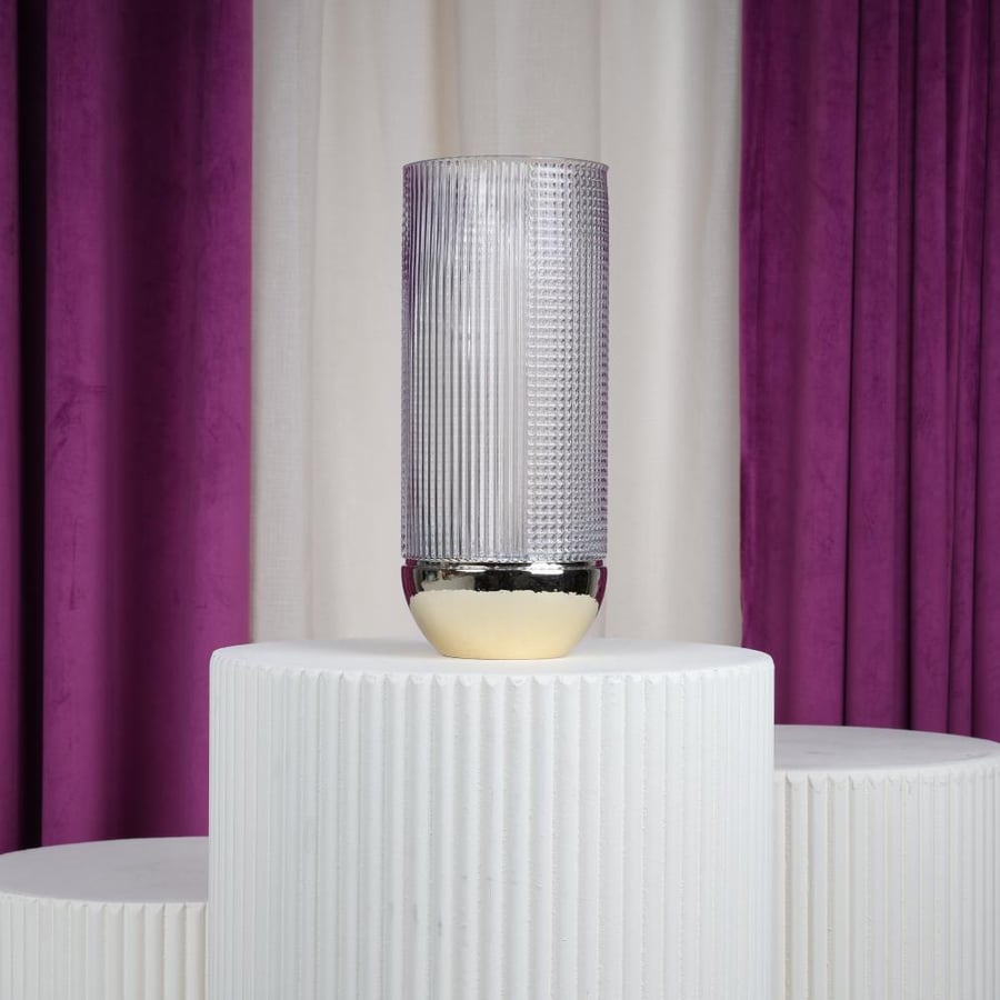 Clear glass vase with a golden base