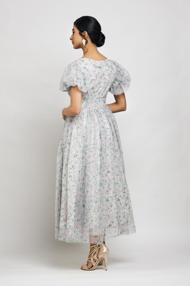 A dress with buttons in front along the entire dress and puffed sleeves