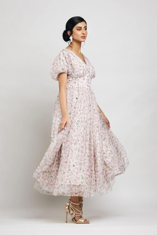A dress with buttons in front along the entire dress and puffed sleeves
