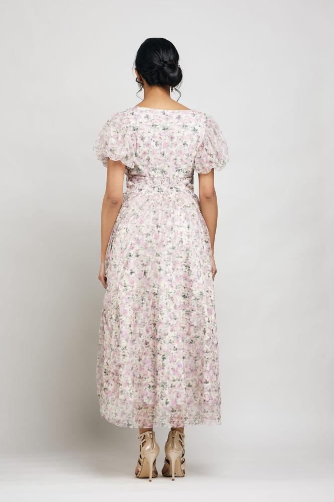 A dress with buttons in front along the entire dress and puffed sleeves