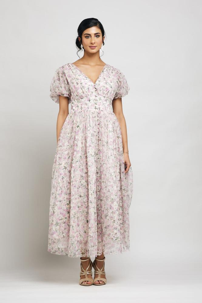 A dress with buttons in front along the entire dress and puffed sleeves