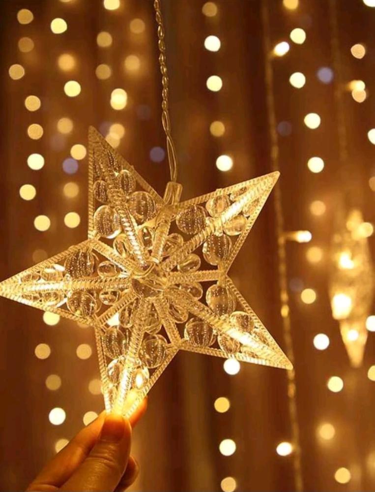 Curtain lighting with star and crescent shapes with yellow lighting