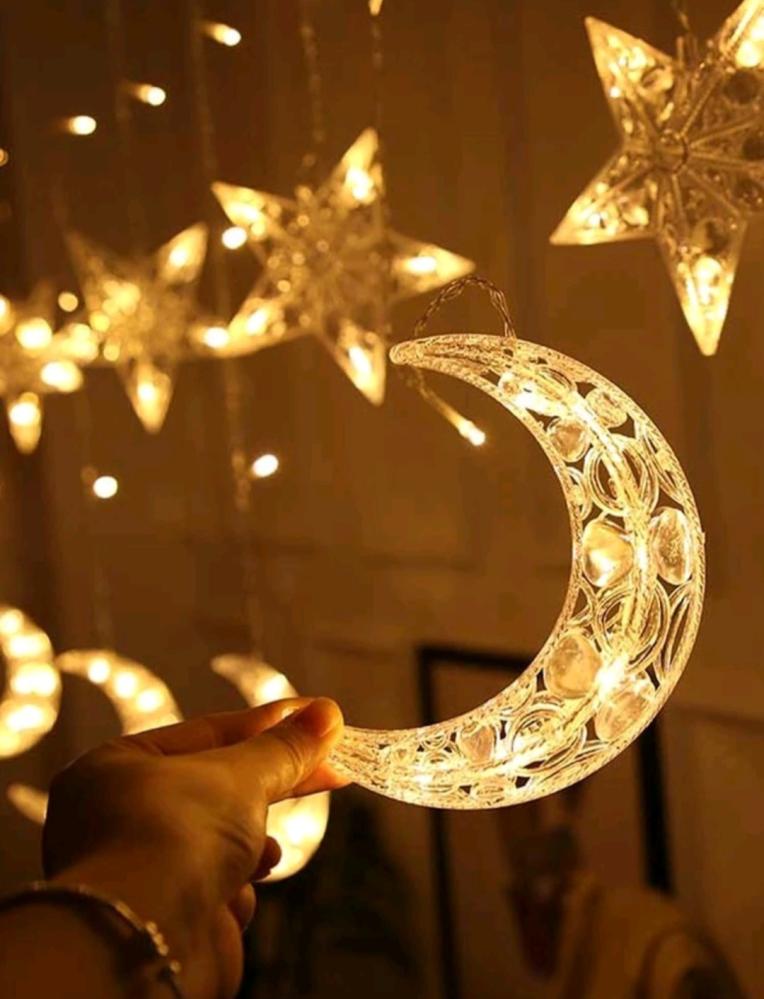 Curtain lighting with star and crescent shapes with yellow lighting