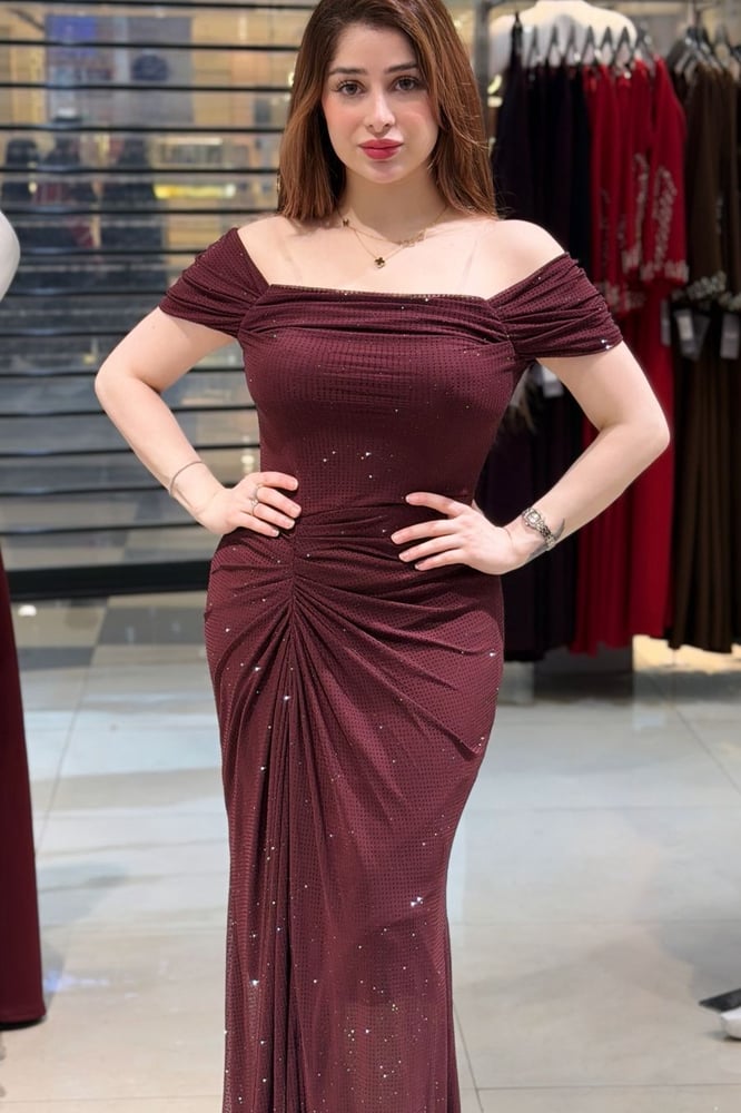 A dress in its dark maroon color and its design that combines simplicity and luxury