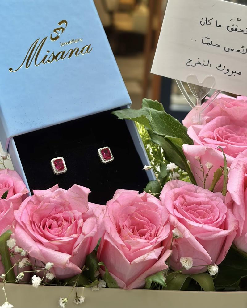 A gift of a rectangular ruby stone ring with roses