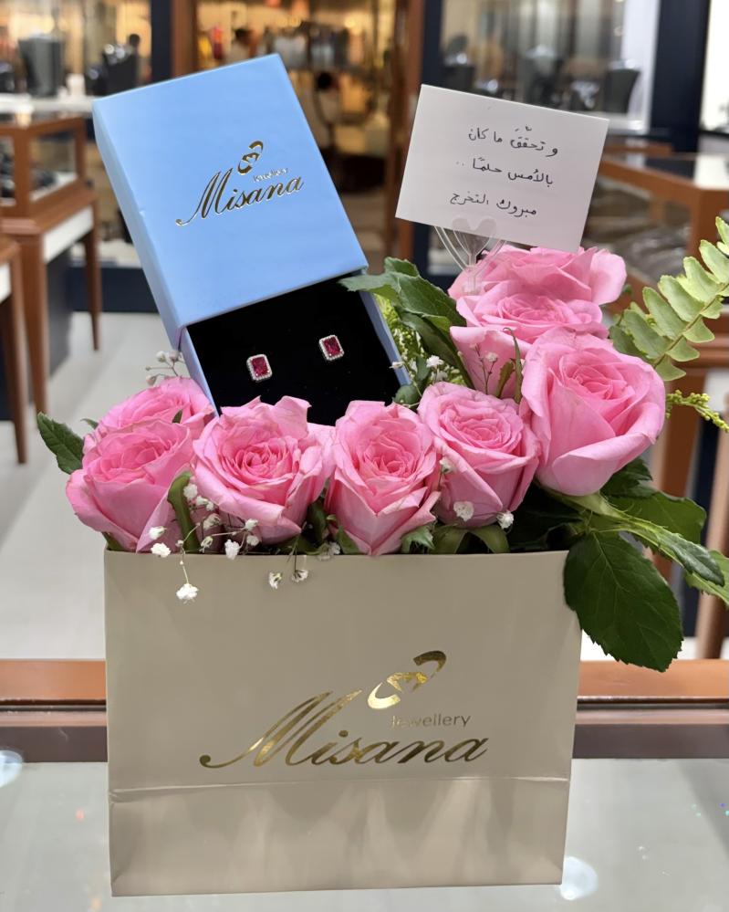 A gift of a rectangular ruby stone ring with roses