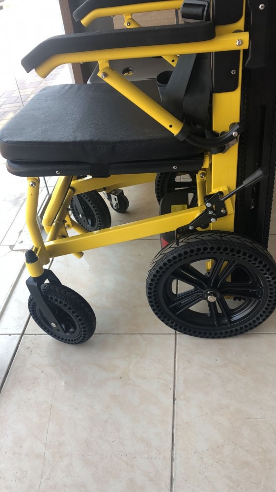 Electric stair chair with large tires, covered with fiber and leather
