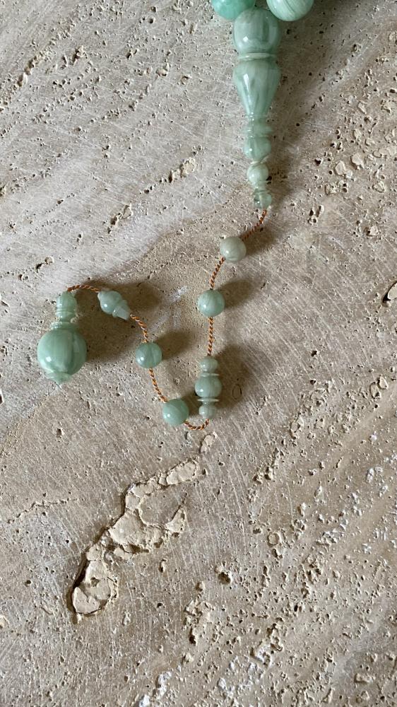 A prayer bead of two bills