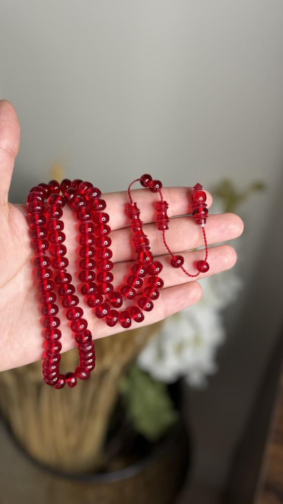 A transparent red Fatoran rosary with a pointed tip