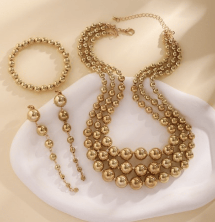 A set with a design of golden beads
