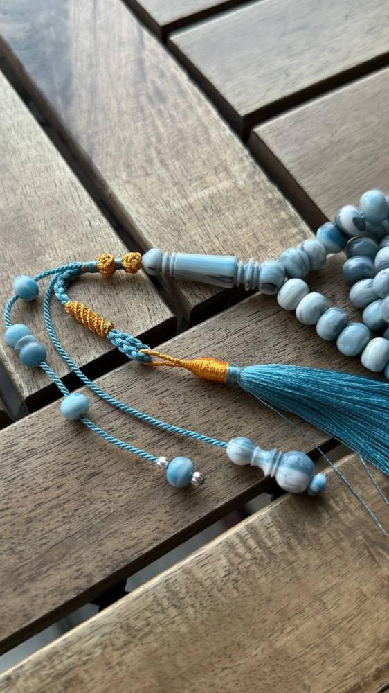 A prayer bead with a gold-plated clasp