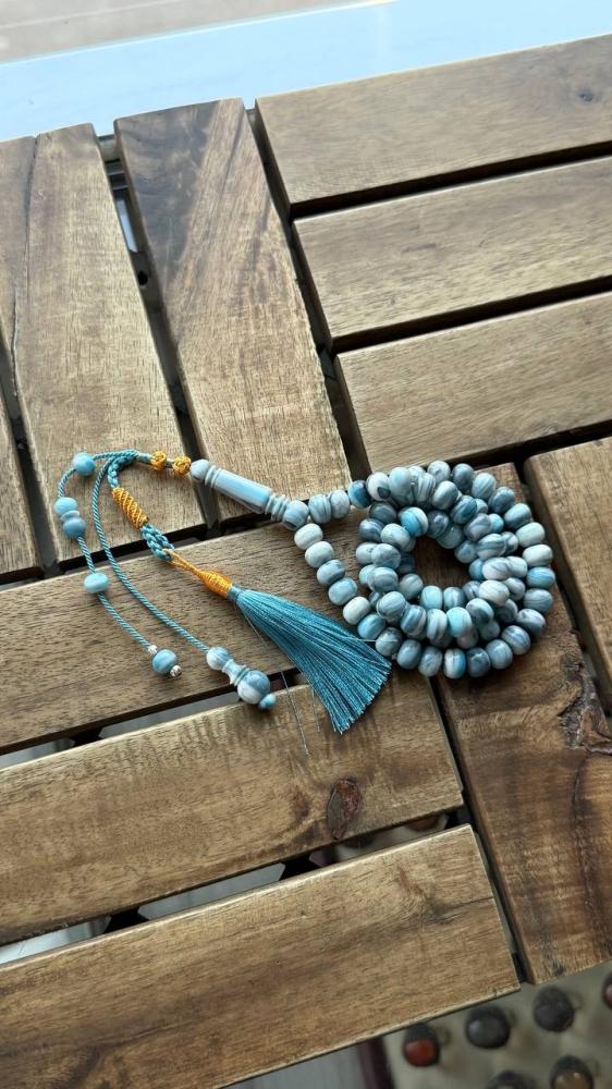 A prayer bead with a gold-plated clasp