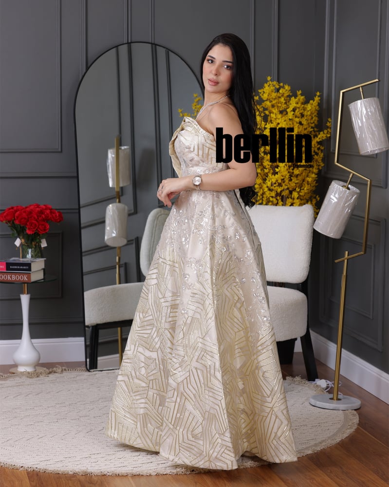 A beige top dress adorned with luxurious raised computer embroidery.