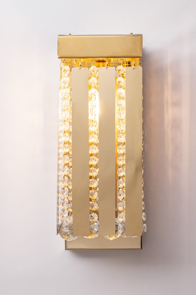 Modern wall panel with crystal and steel comments, gold color