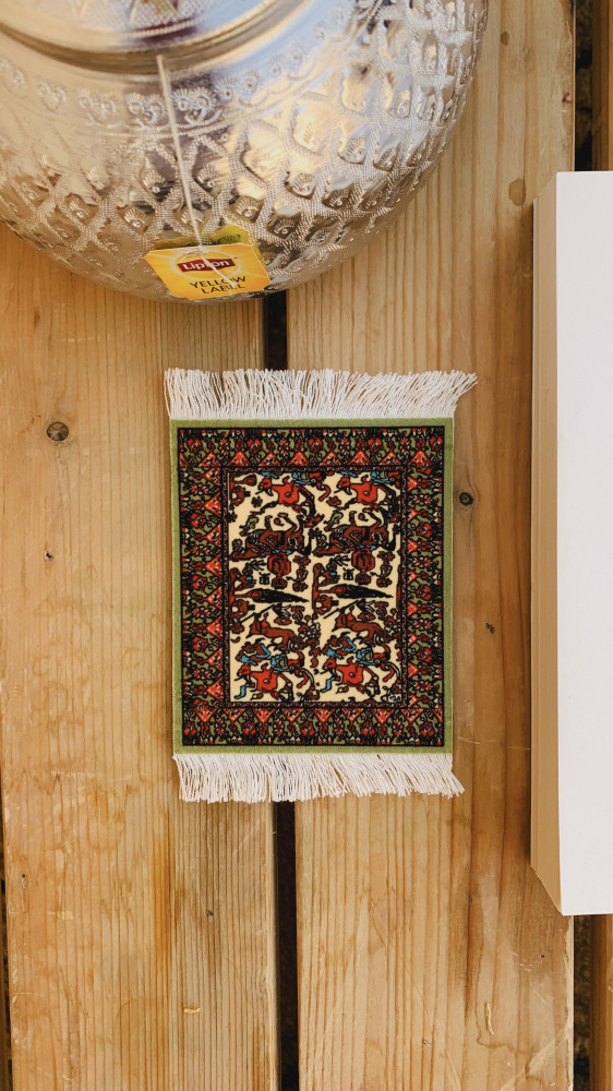 Decorative green carpet coaster.