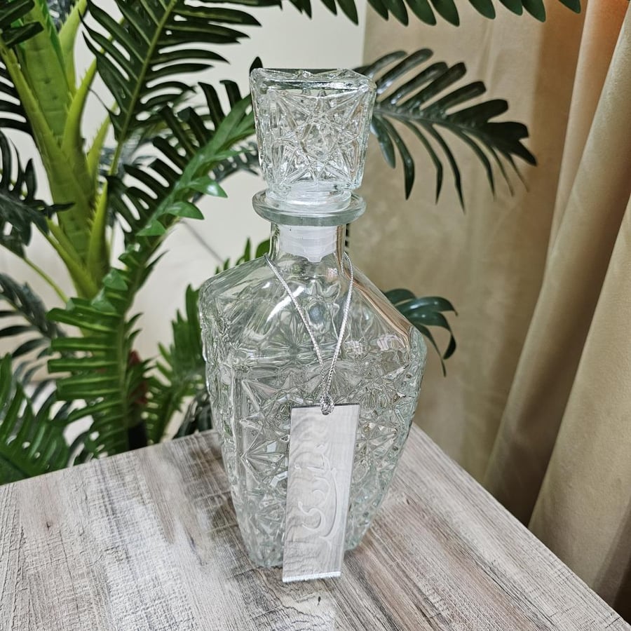 A bottle of juice with a hook