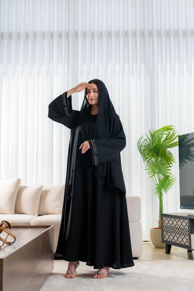 عباية زمرد السوداء بتفاصيل خضراء على الاكمام