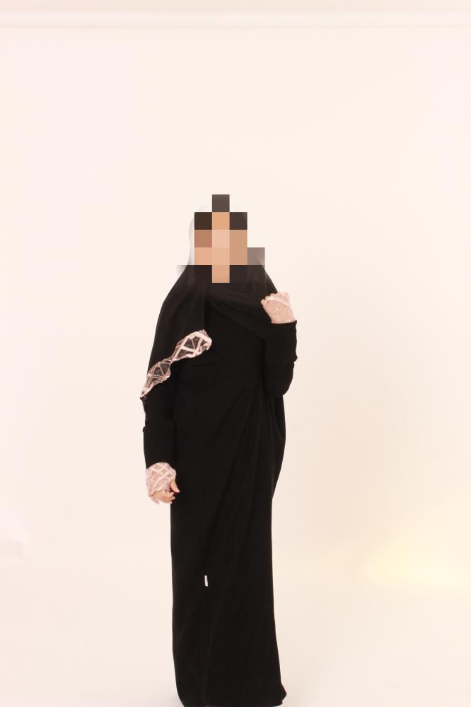Black abaya with pink details.