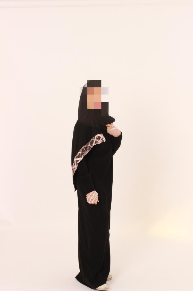 Black abaya with pink details.