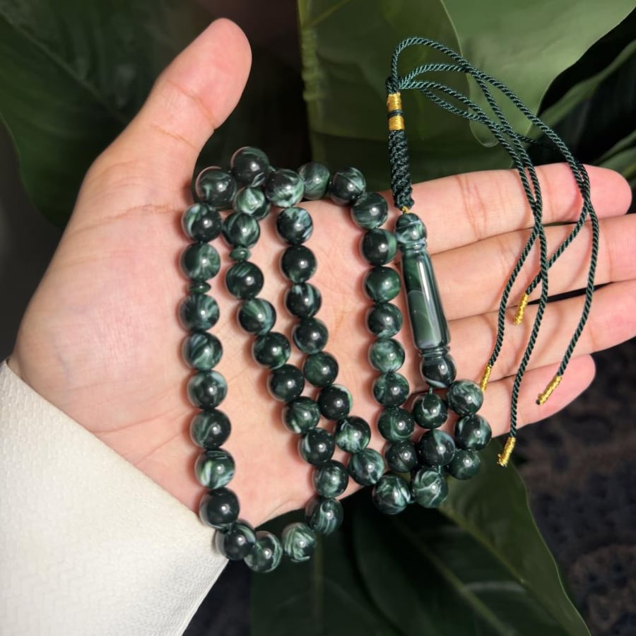 A prayer bead with a clasp - a tassel with a tassel
