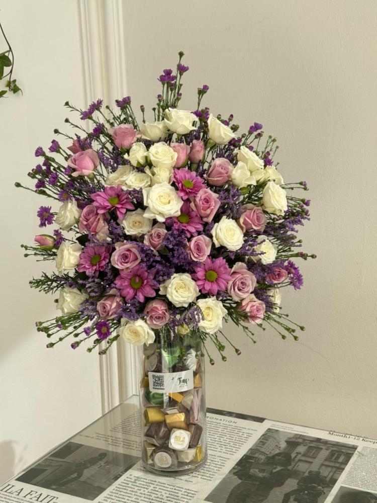 Vase of roses with half a roll