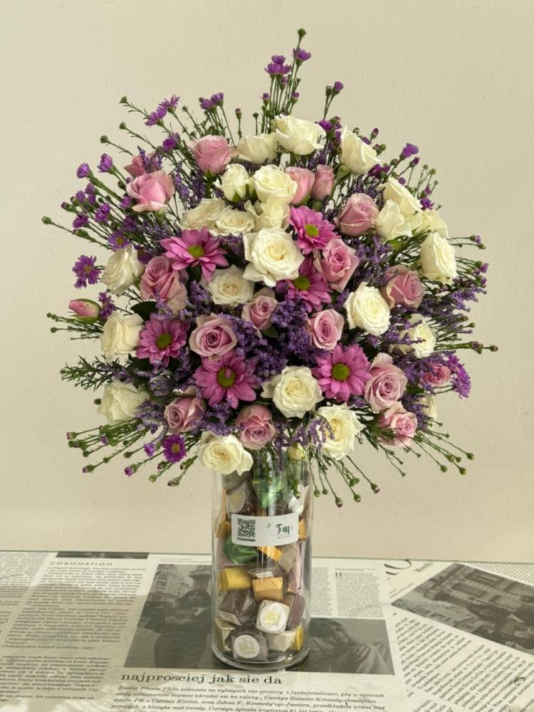 Vase of roses with half a roll