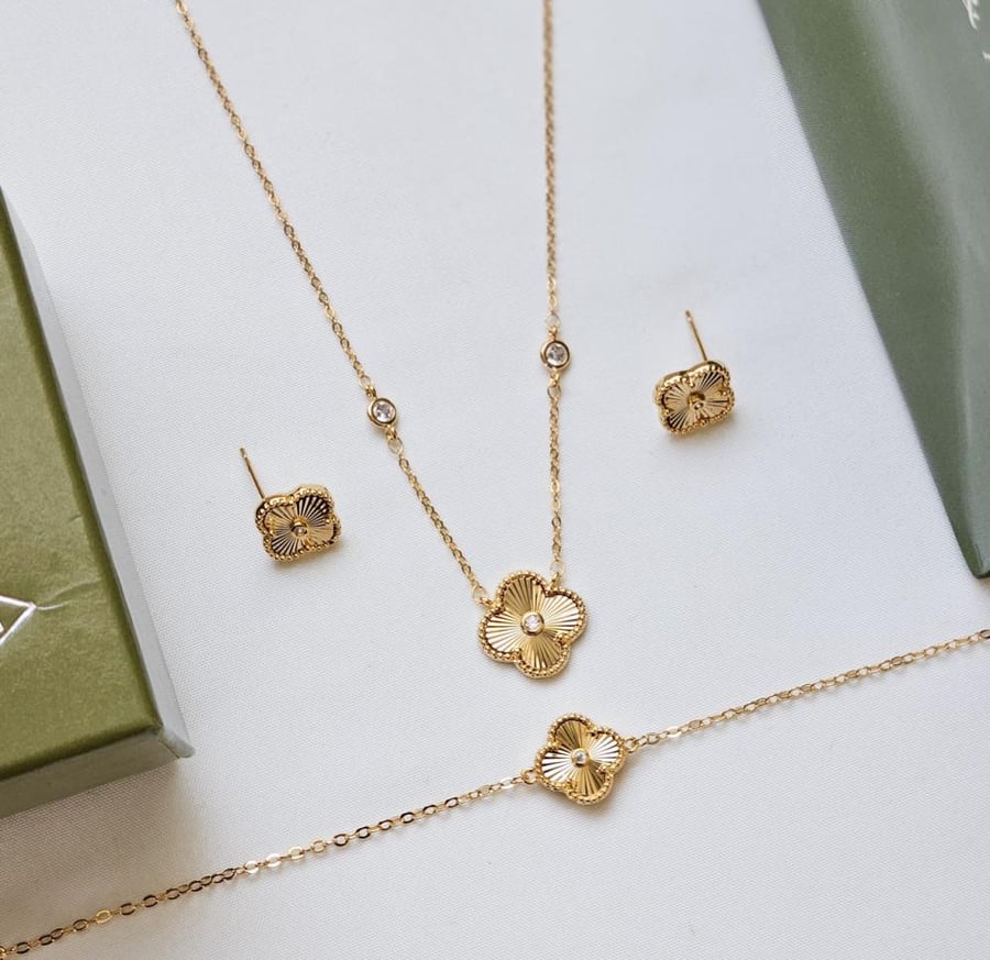 Van Cleef gold necklace, bracelet, and earrings set with accessories