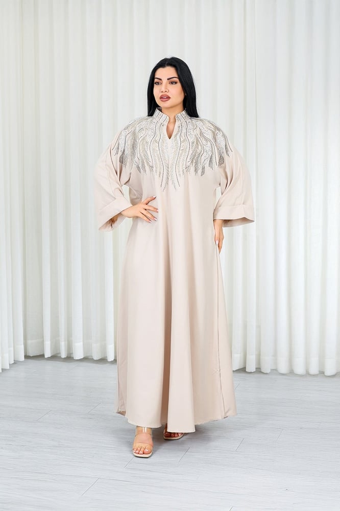 A long, ankle-length fabric jalabiya decorated with vertical embroidery on the chest.