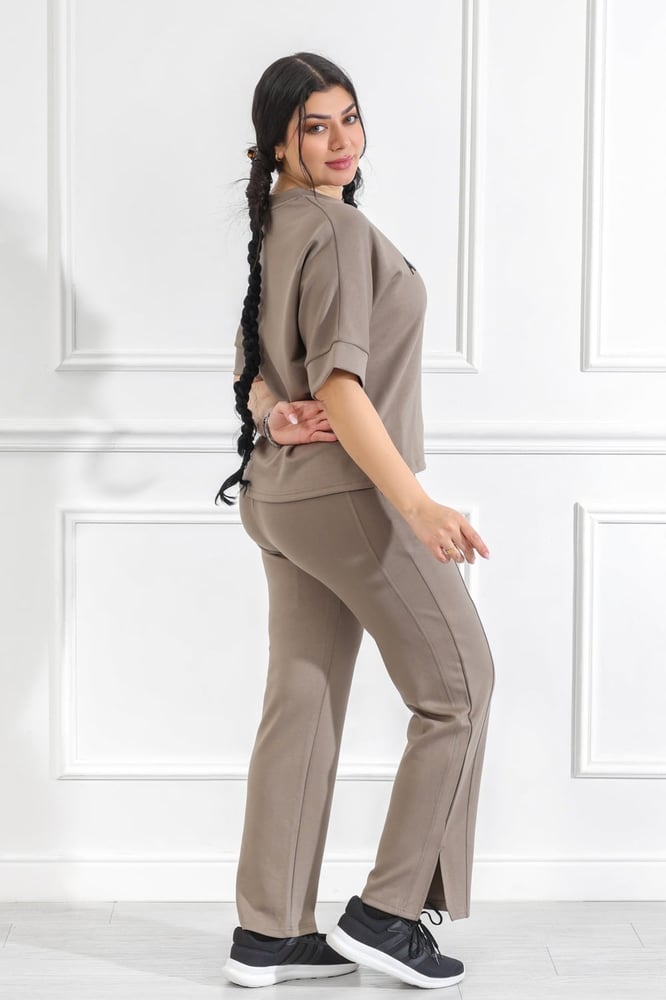 Women's casual medical tracksuit with mid-length sleeves, featuring a medium-sized letter print on the t-shirt and plain pants with a pocket and a side slit at the bottom of the pants.