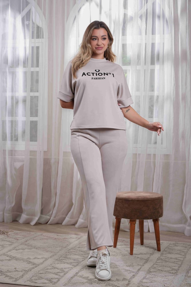Women's casual medical tracksuit with mid-length sleeves, featuring a medium-sized letter print on the t-shirt and plain pants with a pocket and a side slit at the bottom of the pants.