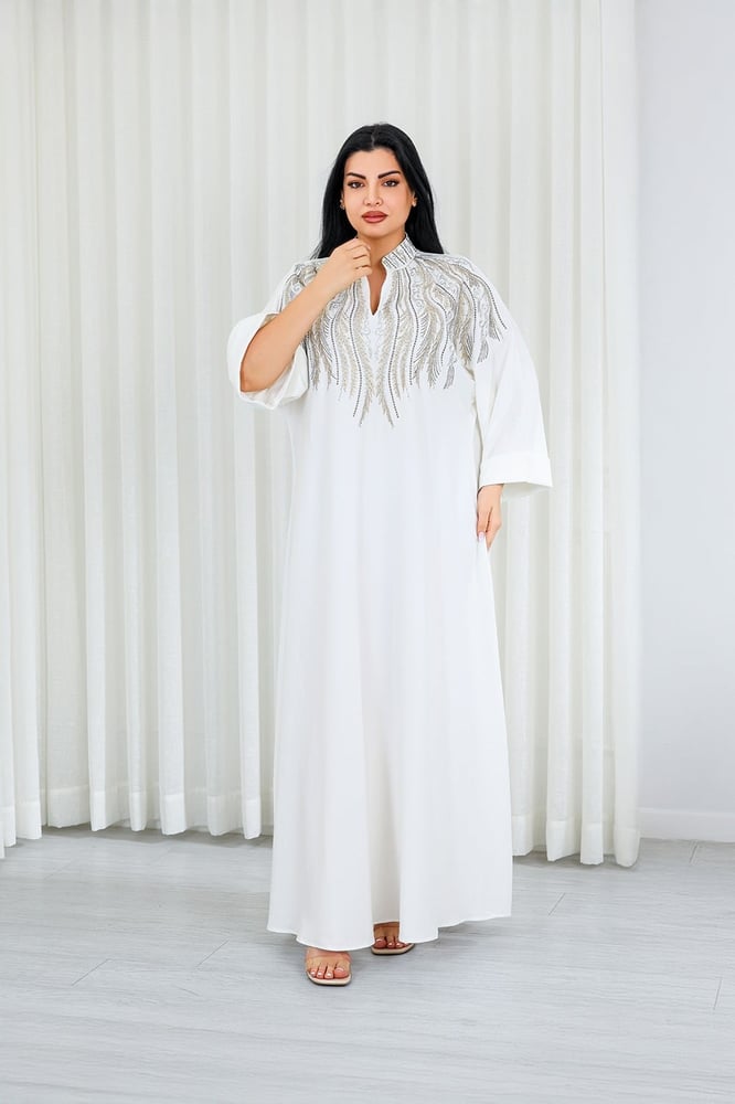 A long, ankle-length fabric jalabiya decorated with vertical embroidery on the chest.