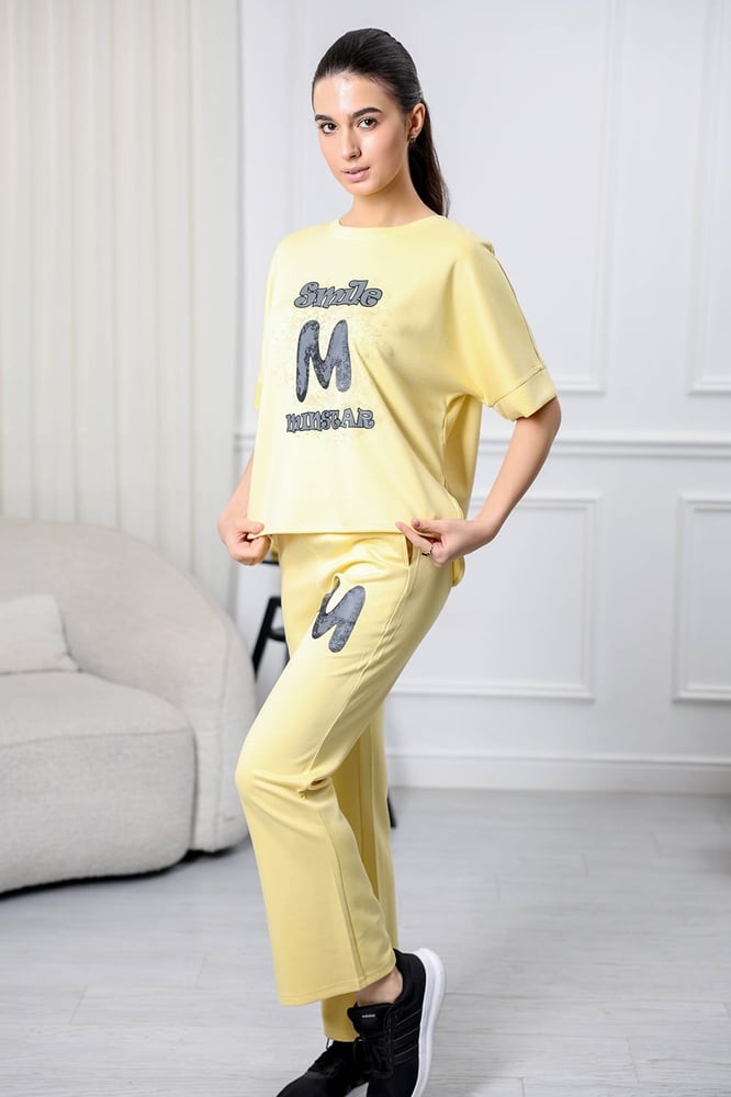 Women's casual tracksuit: T-shirt with elbow-length sleeves featuring a large print on the chest in gray, and pants with a wide, gathered waist.