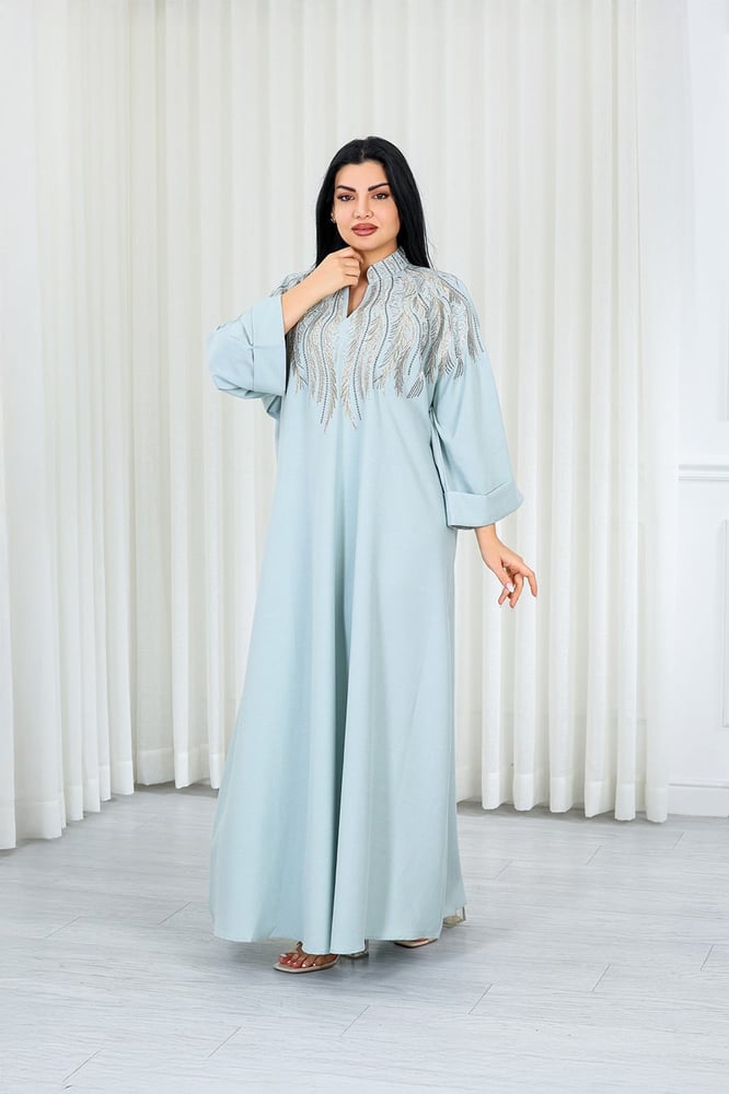 A long, ankle-length fabric jalabiya decorated with vertical embroidery on the chest.