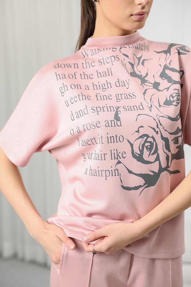 Women's casual tracksuit: mid-length sleeve t-shirt with a high neck featuring a distinctive print and plain pants.