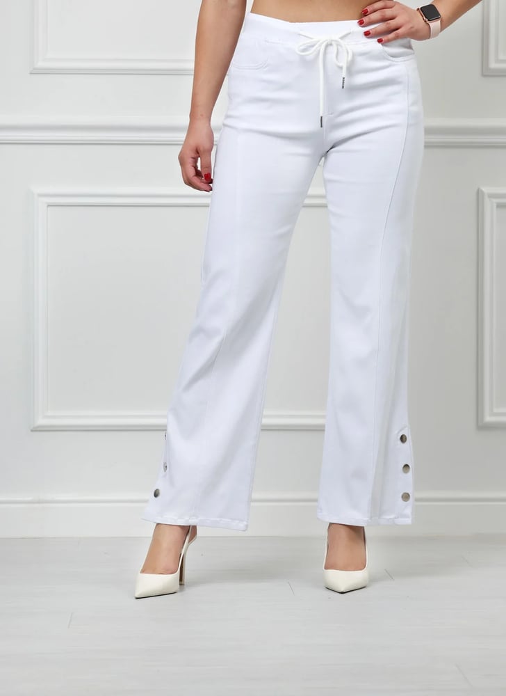 Mid-waisted jeans with an elasticated drawstring, wide leg to the ankle, and buttons.