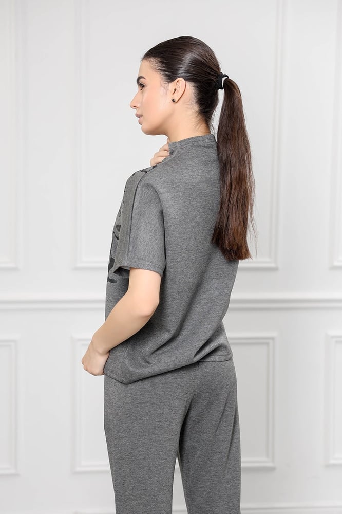 Women's casual tracksuit: mid-length sleeve t-shirt with a high neck featuring a distinctive print and plain pants.