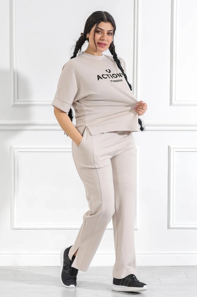 Women's casual medical tracksuit with mid-length sleeves, featuring a medium-sized letter print on the t-shirt and plain pants with a pocket and a side slit at the bottom of the pants.