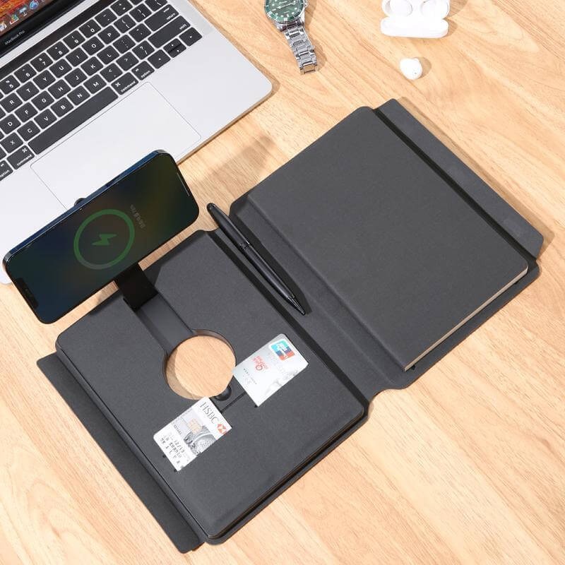 OneX Change Zero power bank lifestyle shot on wooden desk with laptop