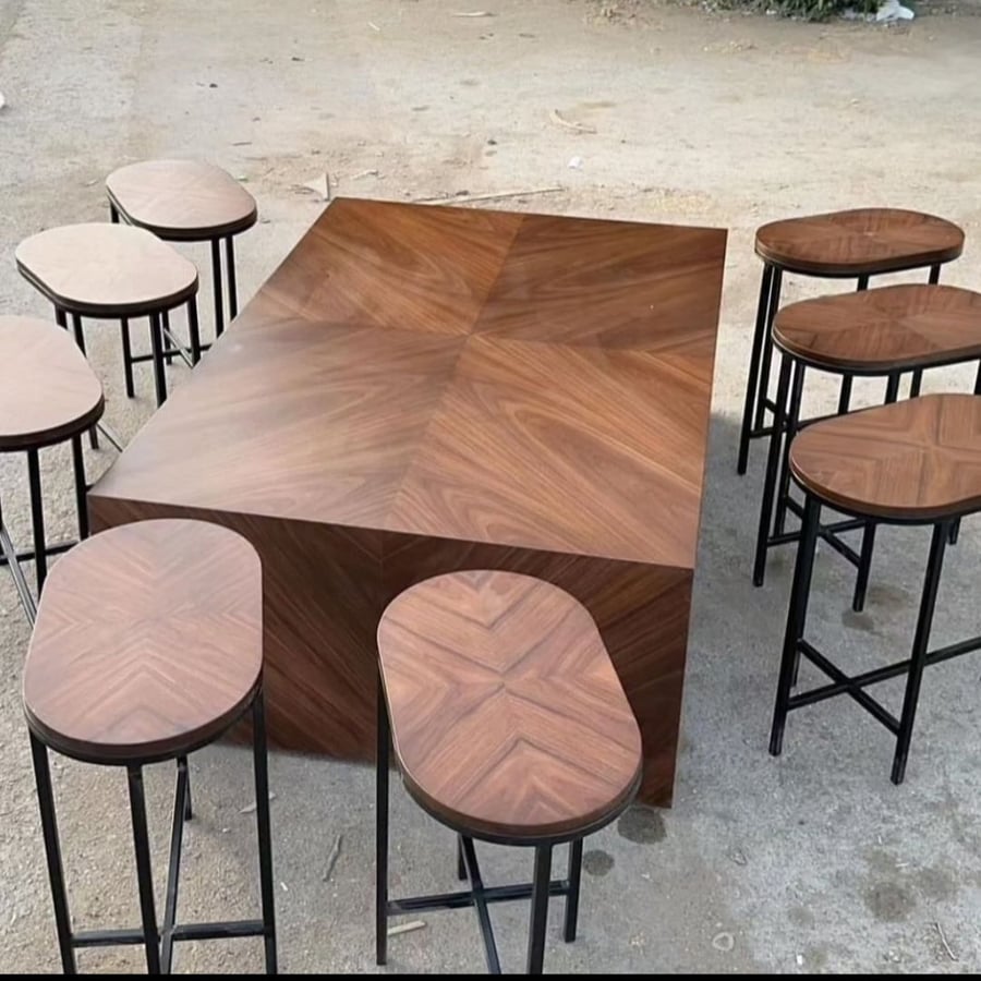A medium table set with walnut veneer