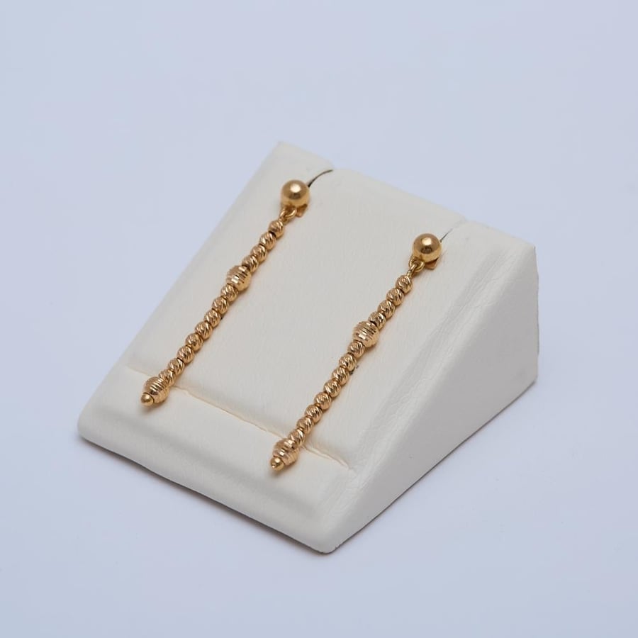 Long and thin gold hoop with Durica design