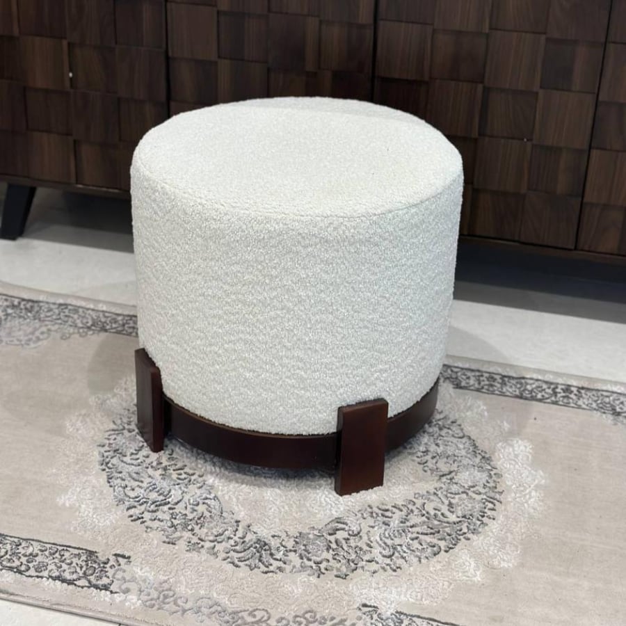 A dark brown wooden pouf chair with a bolster.
