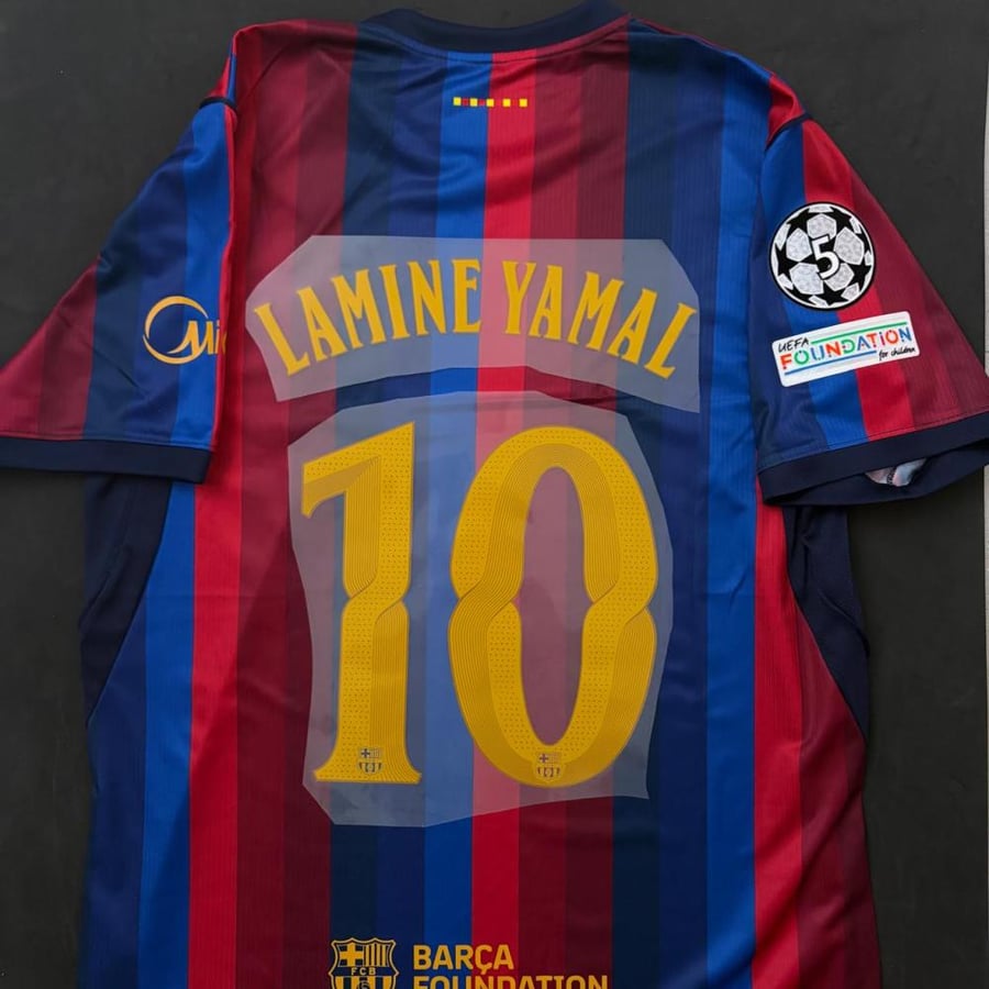 قميص برشلونة الاساسي 26-27 نسخة الجمهور بشعار دوري الابطال