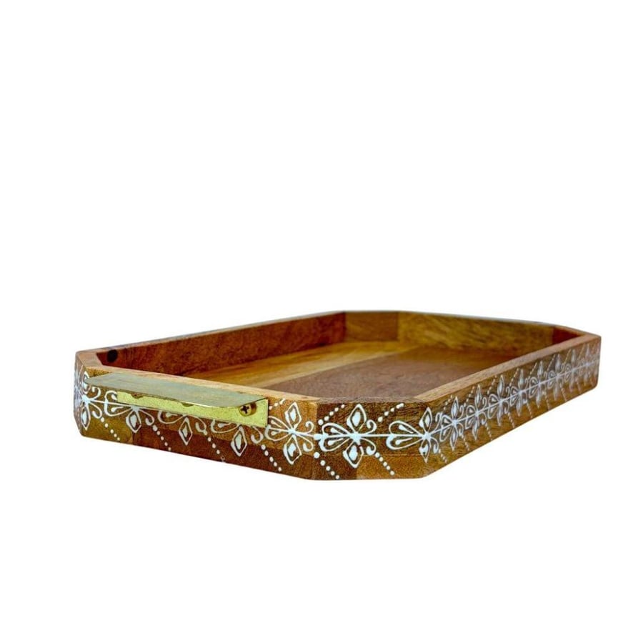A decorated wooden serving tray with copper handles