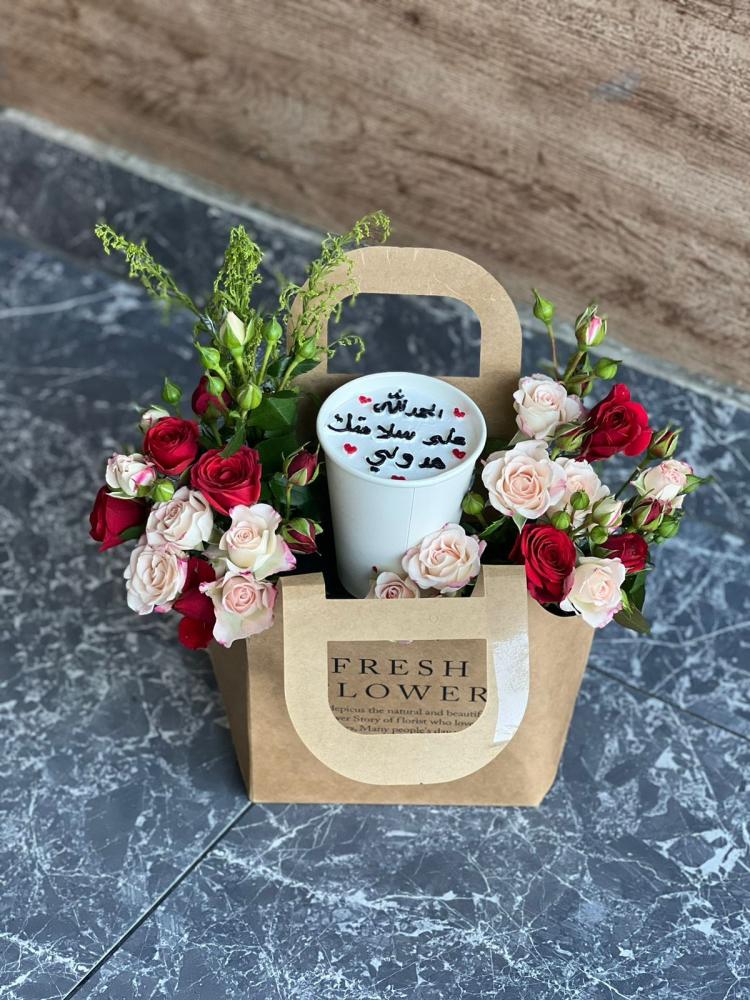 A bouquet of flowers with a cup of cake