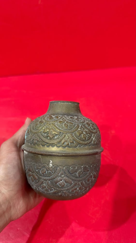 A carved copper vase